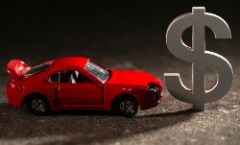 A toy car next to a dollar symbol.