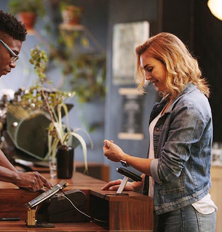 Woman using watch to make payment.
