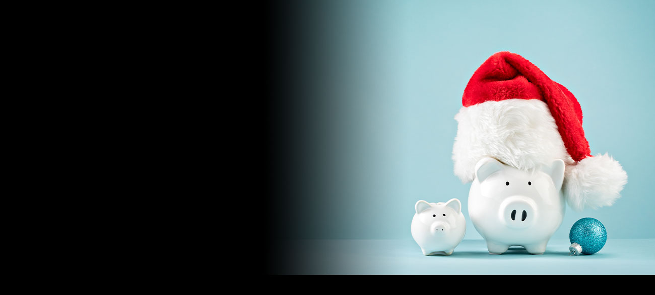 A piggy bank wearing a Christmas hat.
