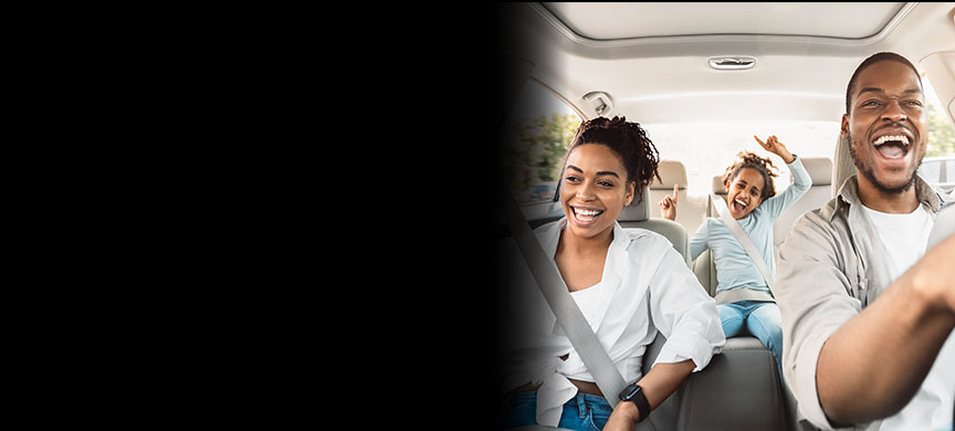 Family smiling in a car.