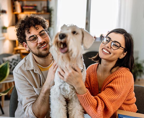 Young couple and their dog at home.
