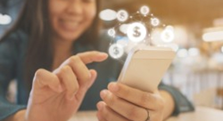 Woman with phone and money icons