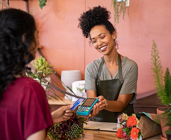 Person paying for flowers with a card.
