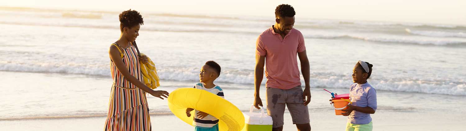 A family at the beach during sunset.