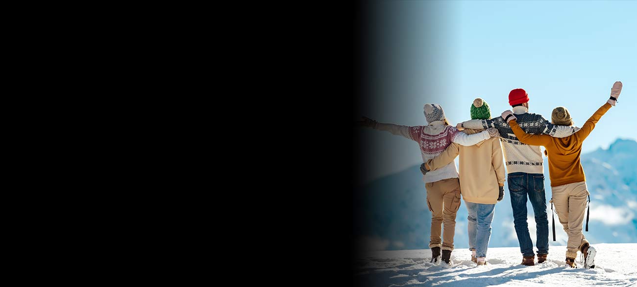 Family on a winter trip looking out at mountains.