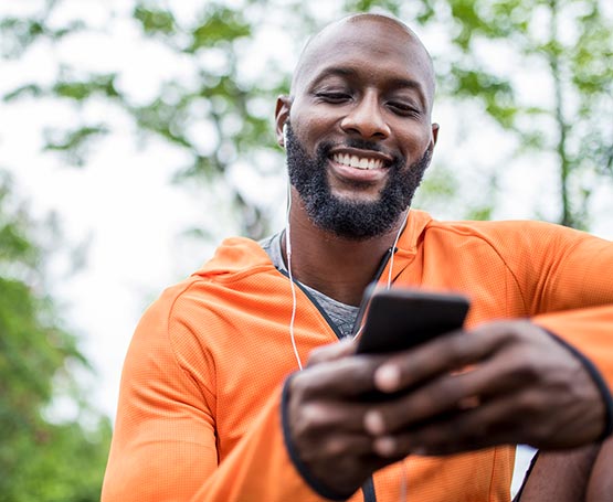 Man looking at his cell phone outdoors.