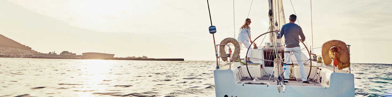 A middle aged couple on a boat during sunset.