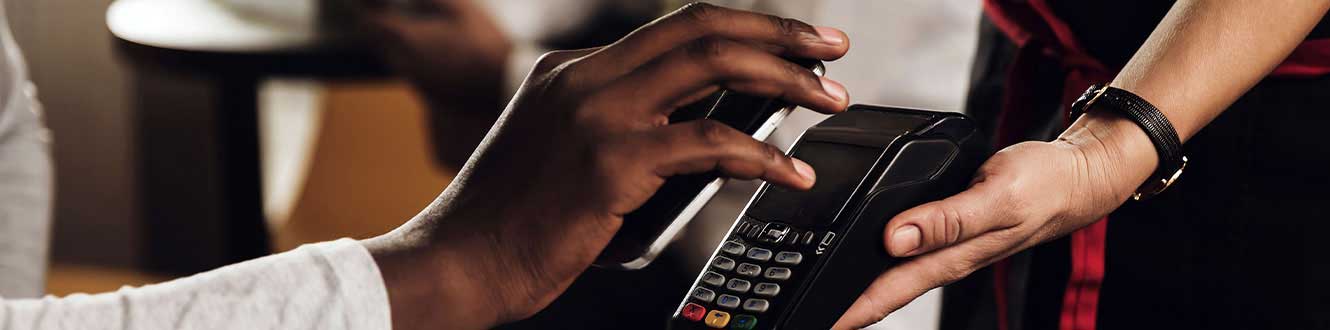 A man uses his cellphone to pay.