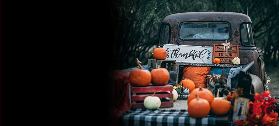 A truck with pumpkins in the bed. 