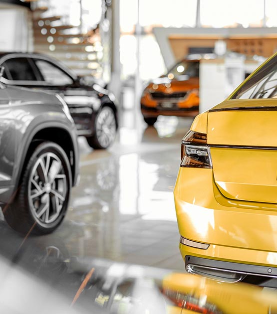 Four cars on a for sale lot.